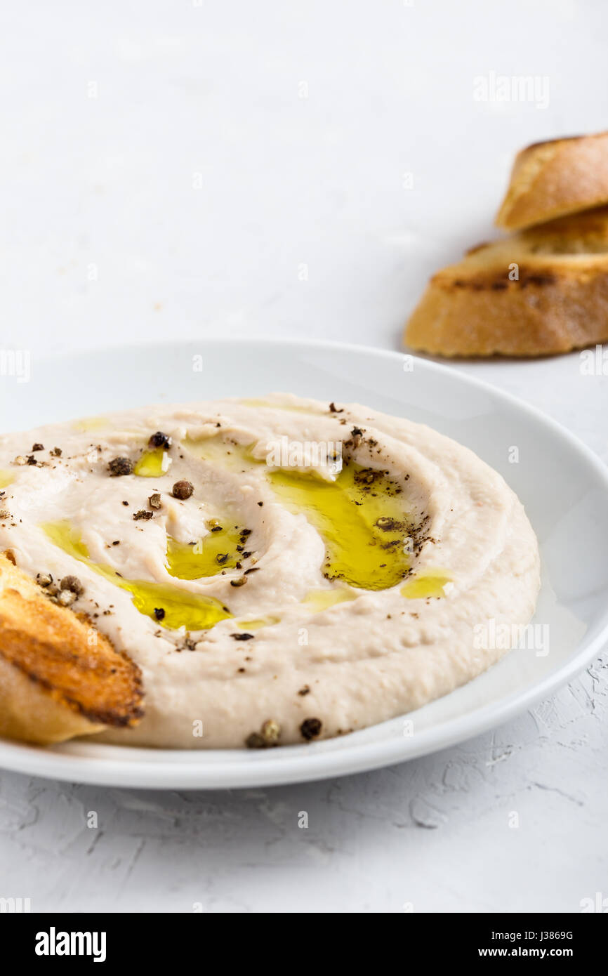 White bean dip on plate, vegan pate side dish, delicious appetizer, snack, or party spread Stock