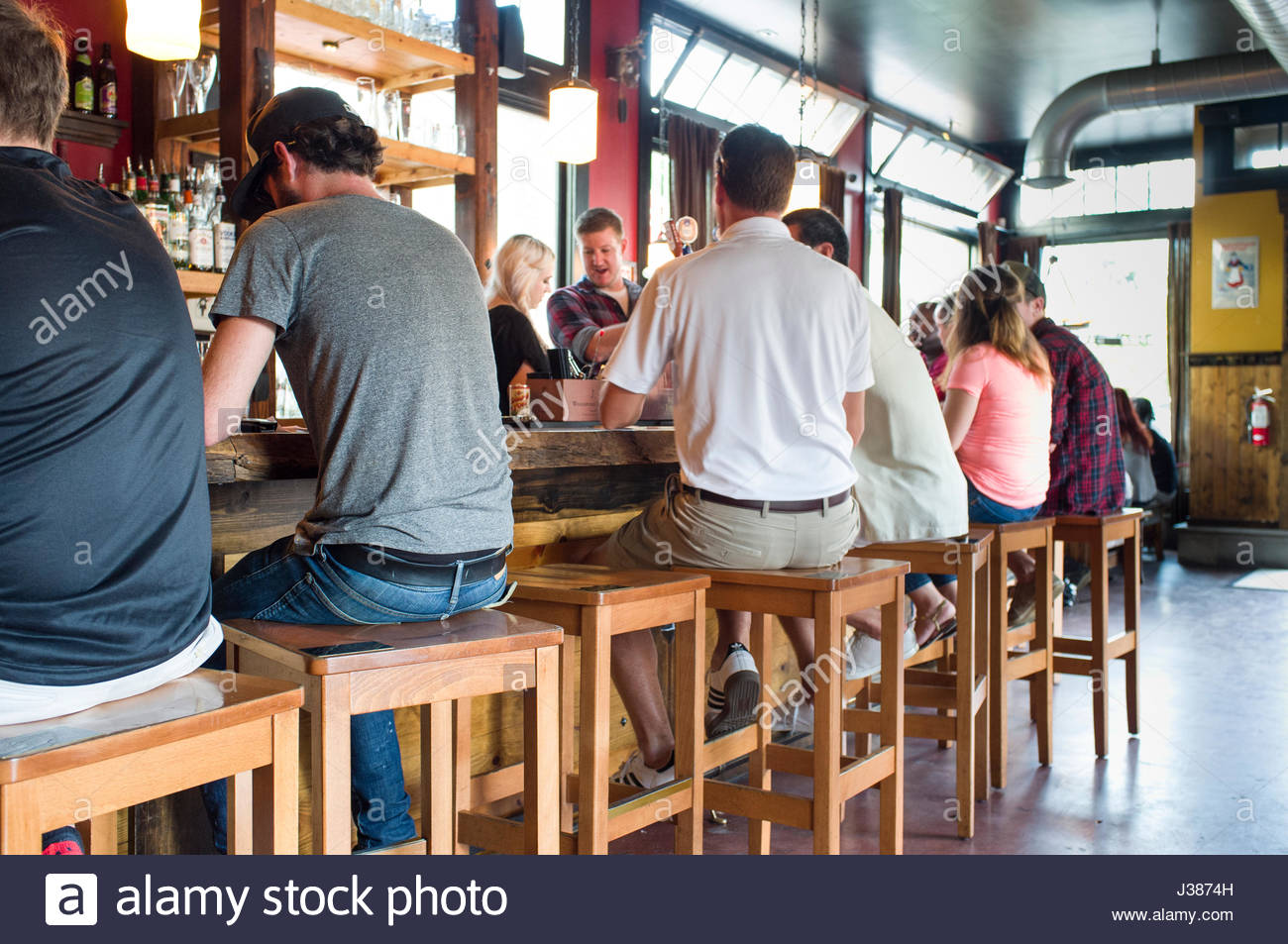 Sitting On Bar Stools Stock Photos & Sitting On Bar Stools Stock Images