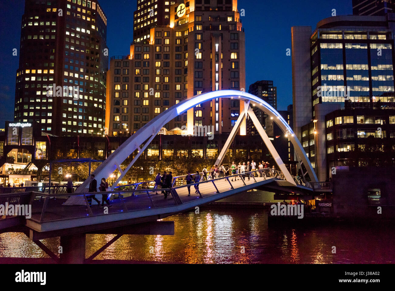 Southbank Pedestrian Bridge, Southgate, Melbourne, VIC 3000, Australia at night with reflections in the Yarra river Stock Photo
