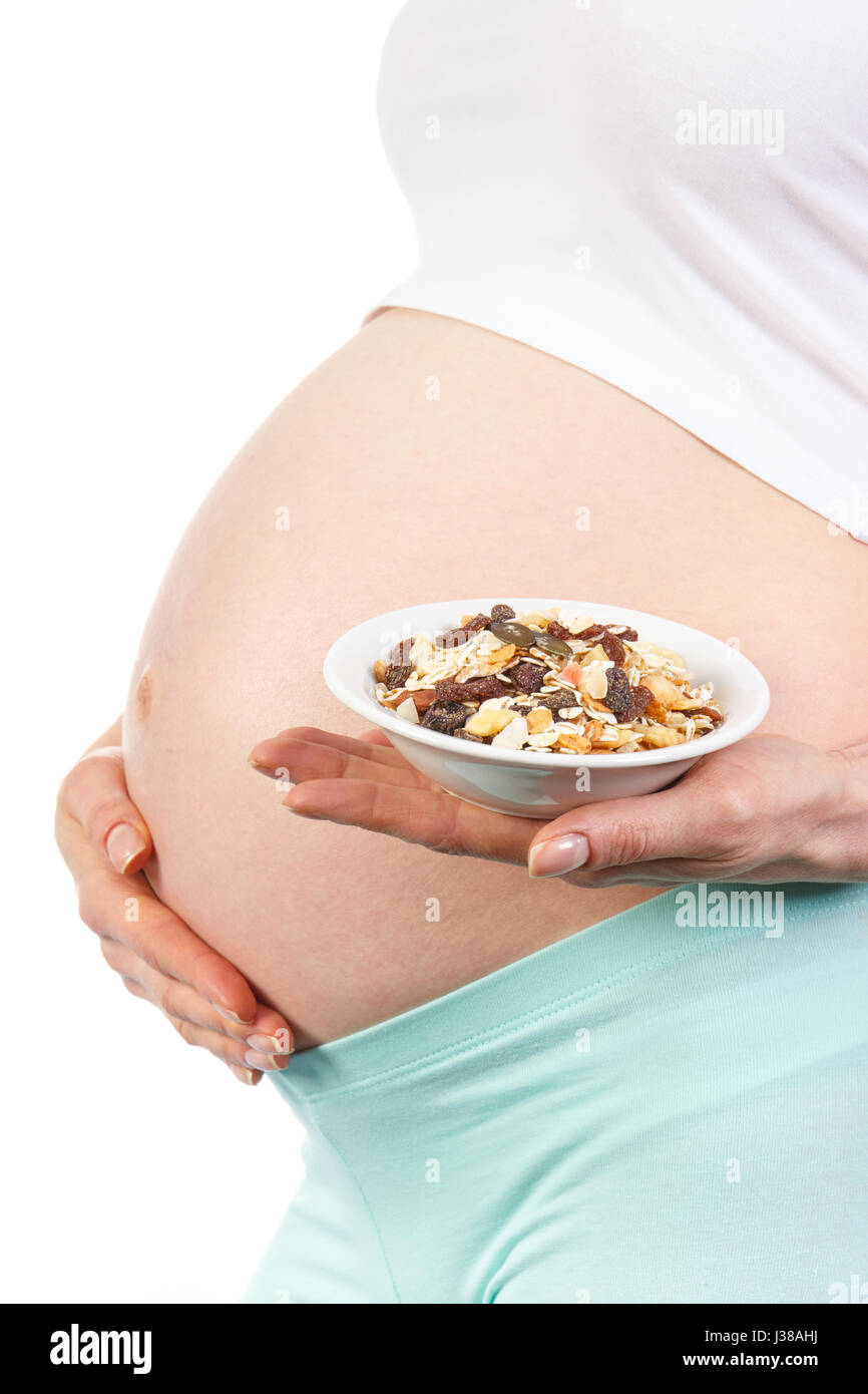 Pregnant woman with portion of crunchy muesli, concept of healthy
