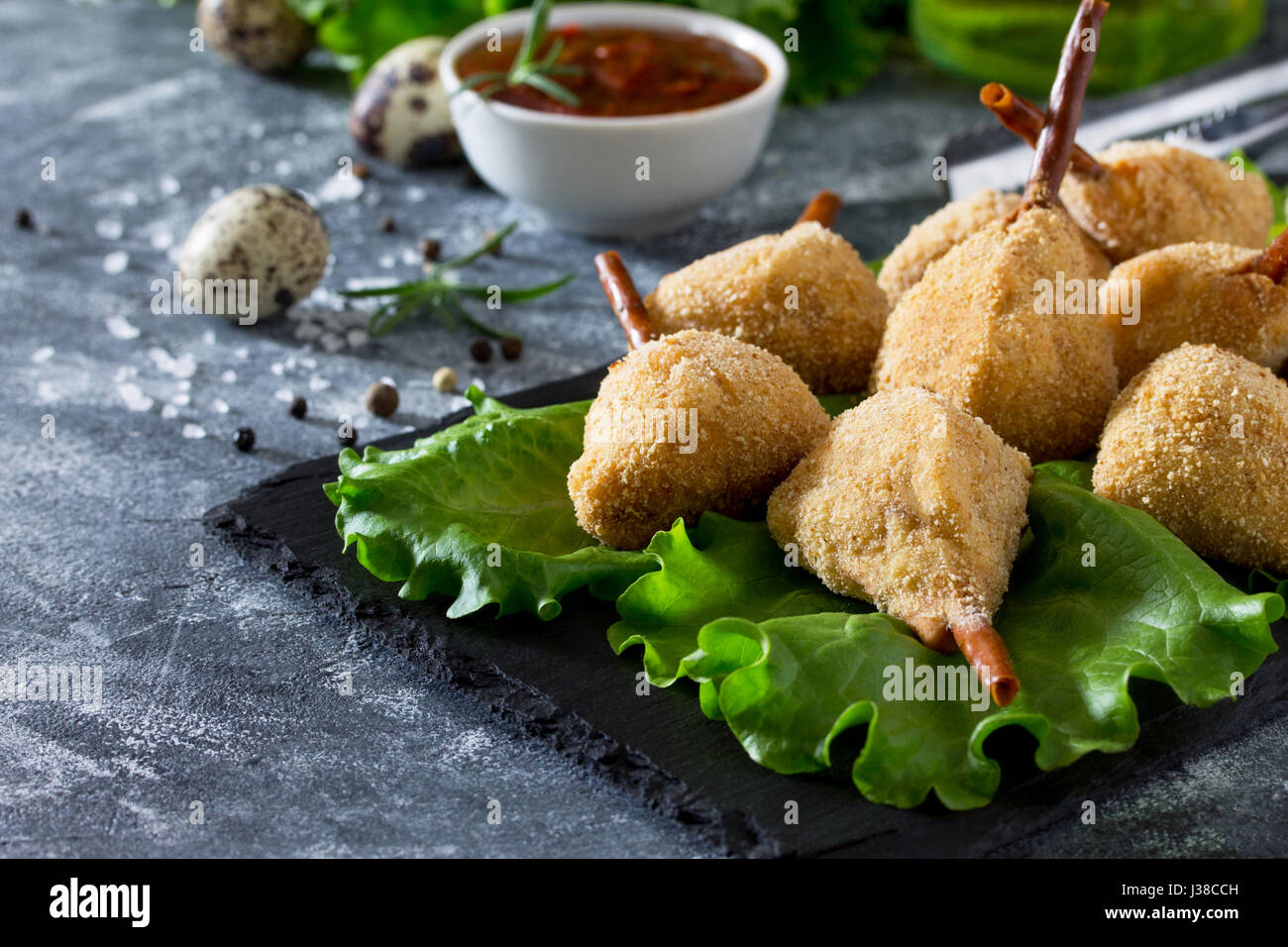 Snack spicy fried quail legs, cutlet in a batter with breaded on the kitchen table. Fast food