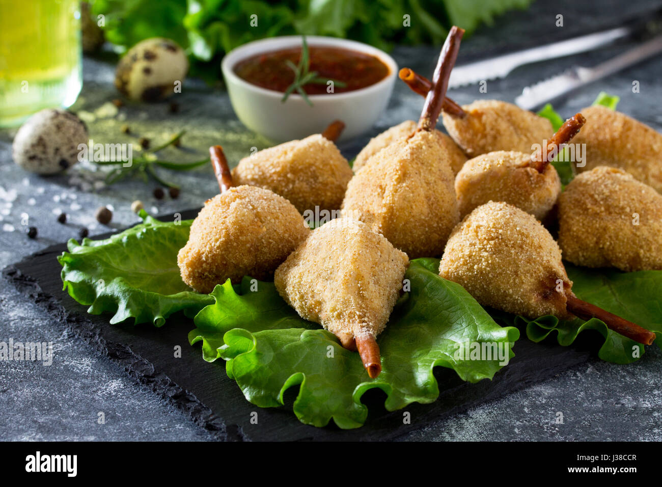 Snack spicy fried quail legs, cutlet in a batter with breaded on the kitchen table. Fast food