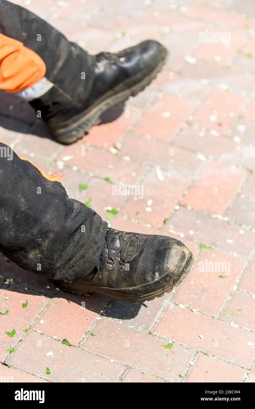The protective boots of a worker relaxing during his lunch break Worker Manual worker Relaxing Protective workwear Protective boots Safety boots Stock Photo