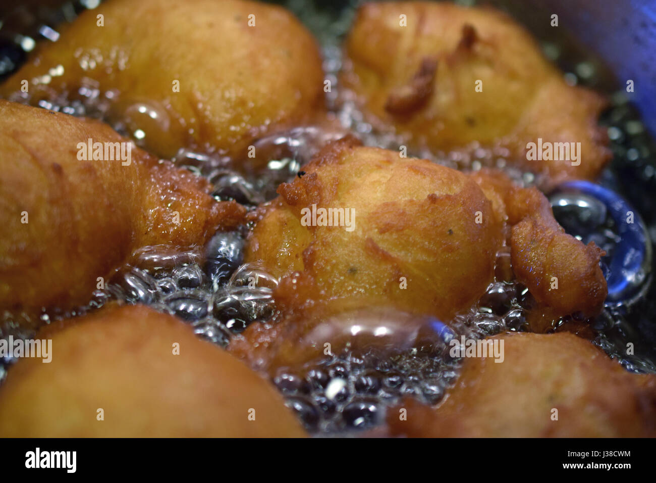 Donuts frying in hot oil Stock Photo Alamy