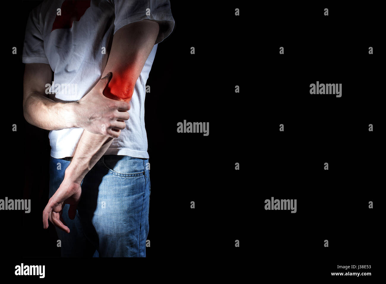 man, holding her painful elbow, arm, experiencing pain, red spot, on