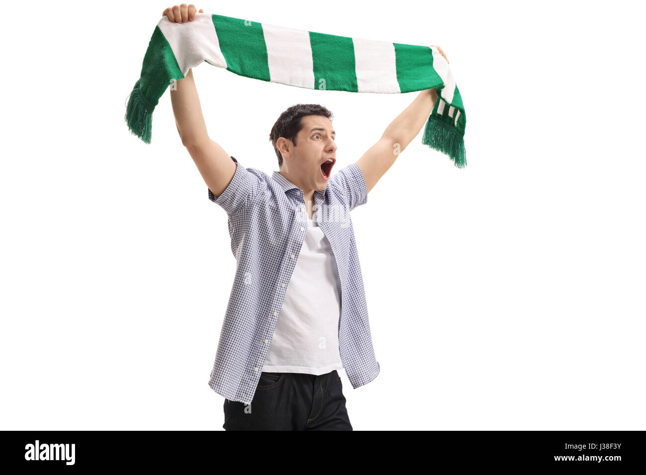 Ecstatic football fan holding a scarf and cheering isolated on white background Stock Photo