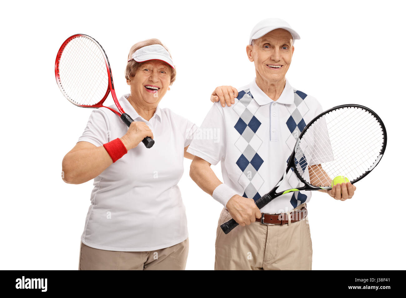 Elderly tennis players looking at the camera and smiling isolated on