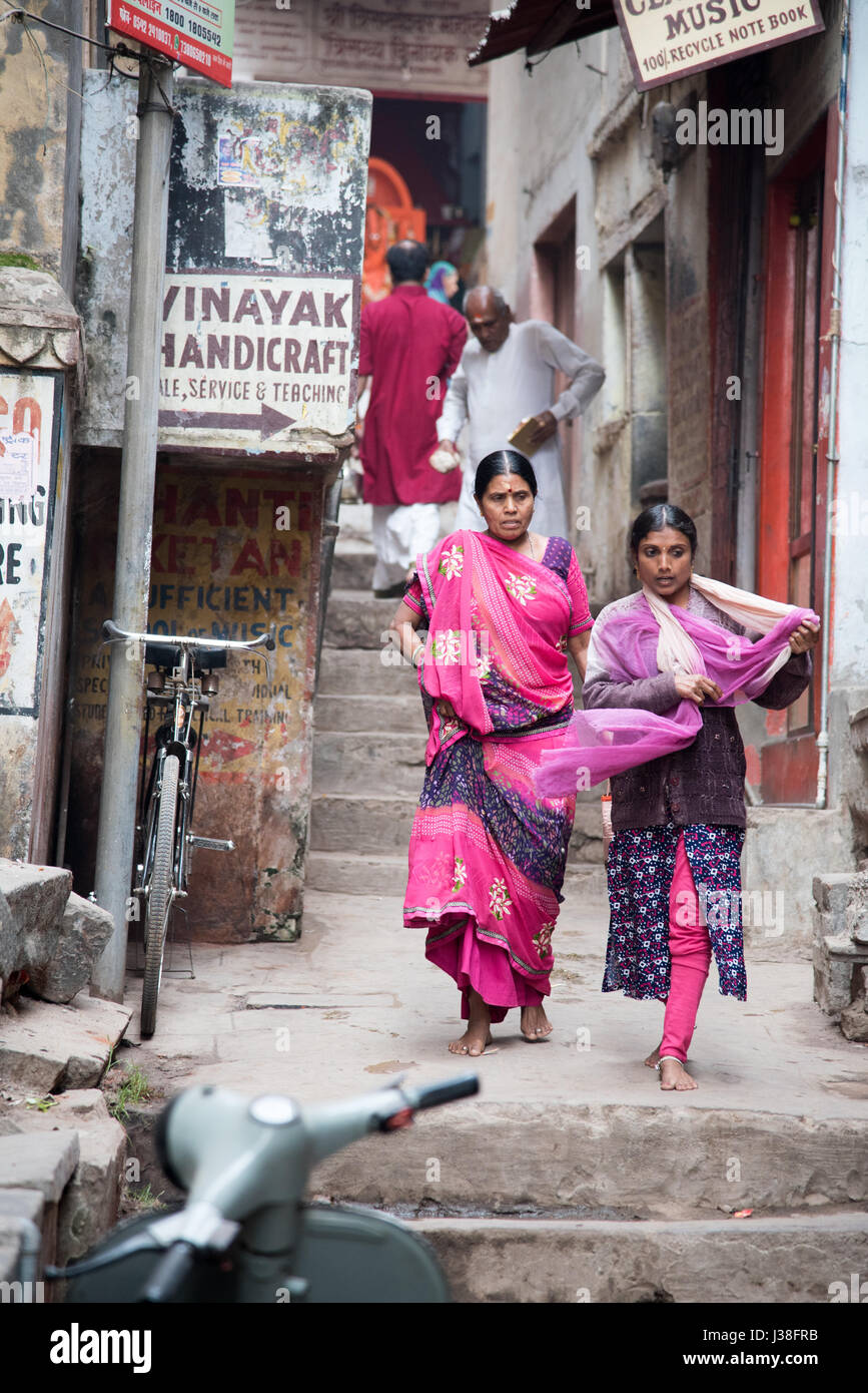 Two women in traditional clothing in a narrow street in Varanasi, India Stock Photo