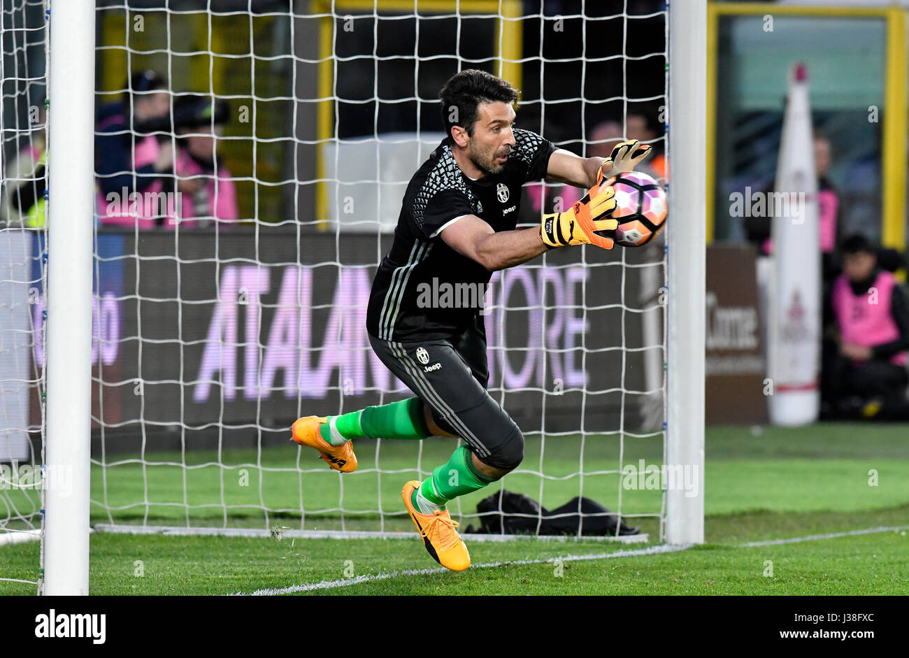 Football goalkeeper saves the ball during a professional match, in Italy. Stock Photo