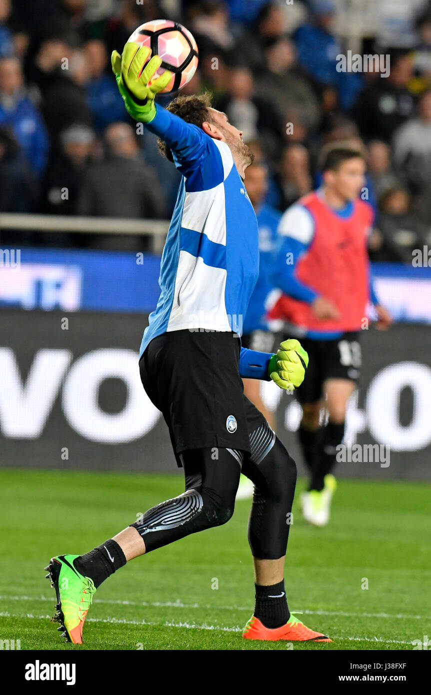 Football goalkeeper saves the ball during a professional match, in Italy. Stock Photo