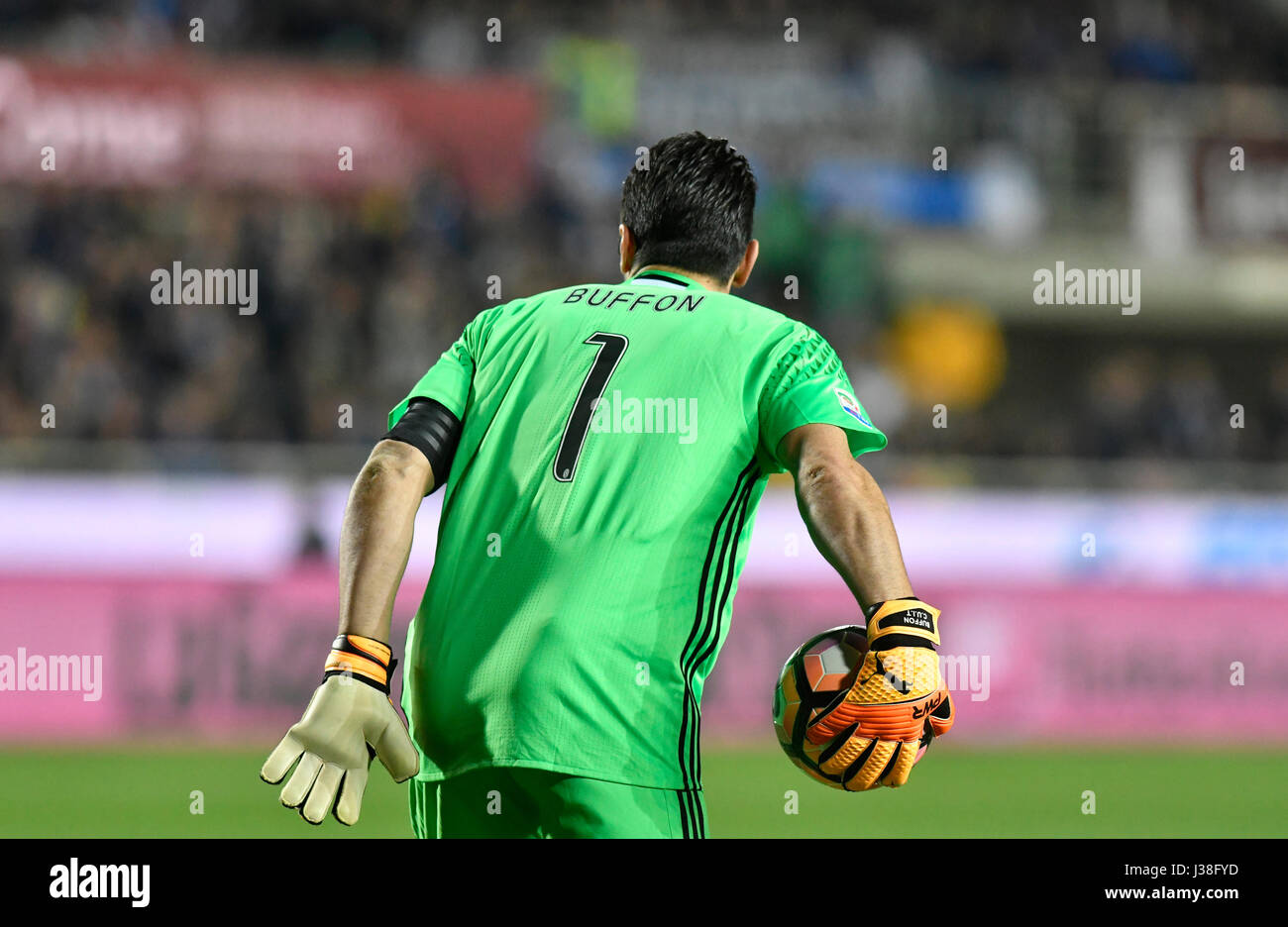 Football goalkeeper saves the ball during a professional match, in Italy. Stock Photo