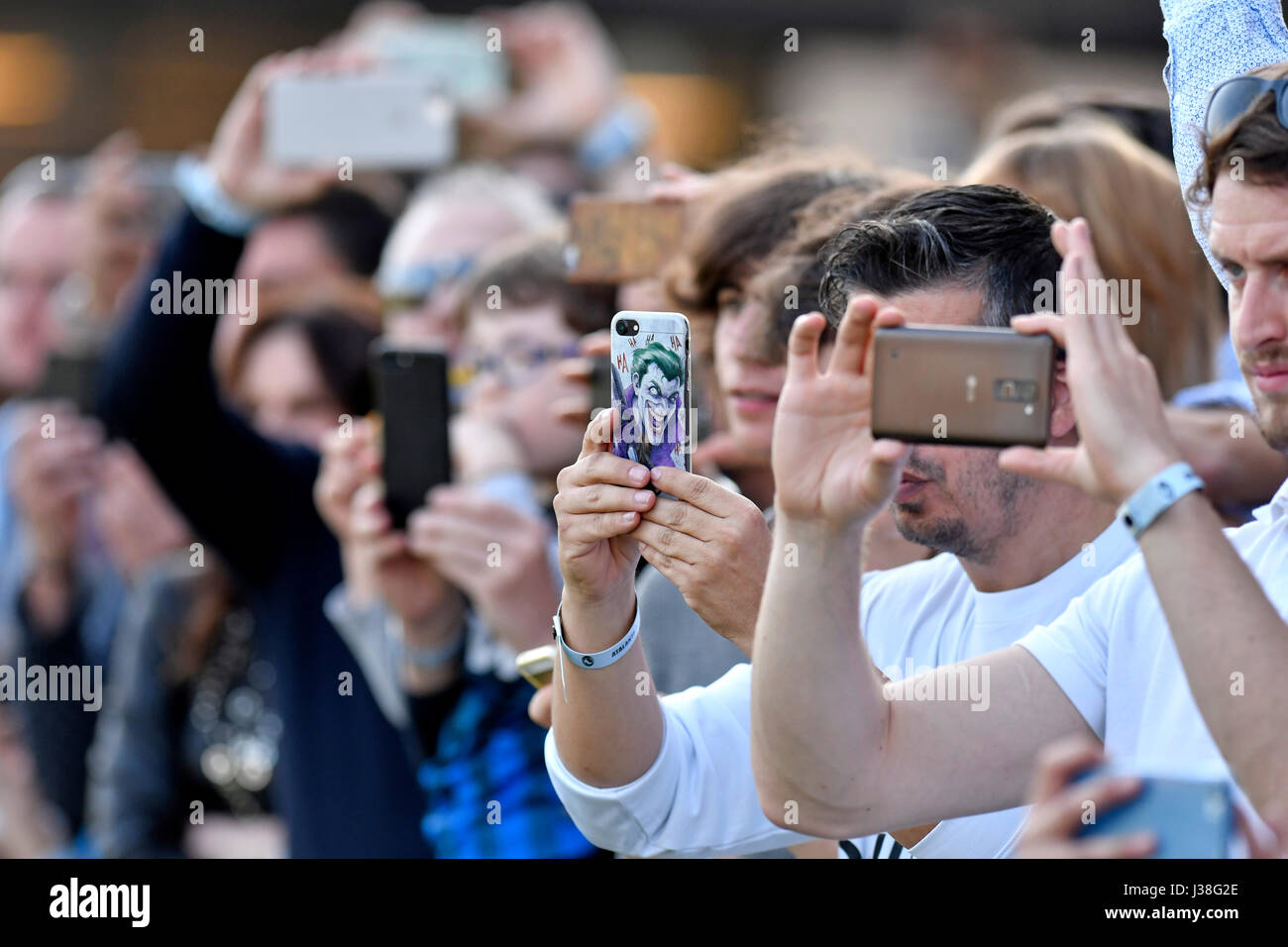 Soccer fans taking photos with their smartphone at the Atalanta stadium, Bergamo, Italy. Stock Photo