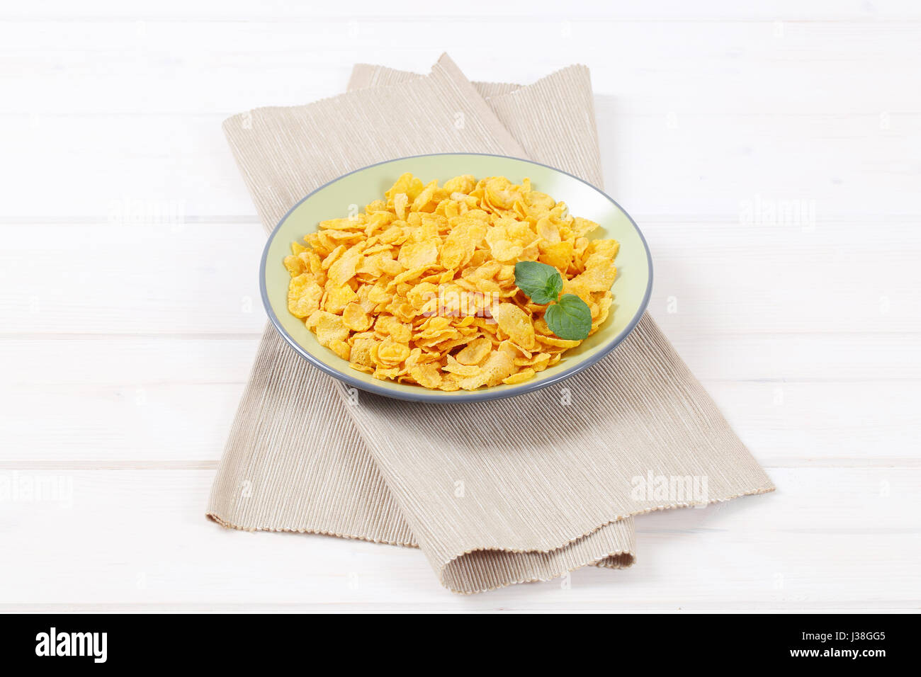 plate of corn flakes on beige place mat Stock Photo