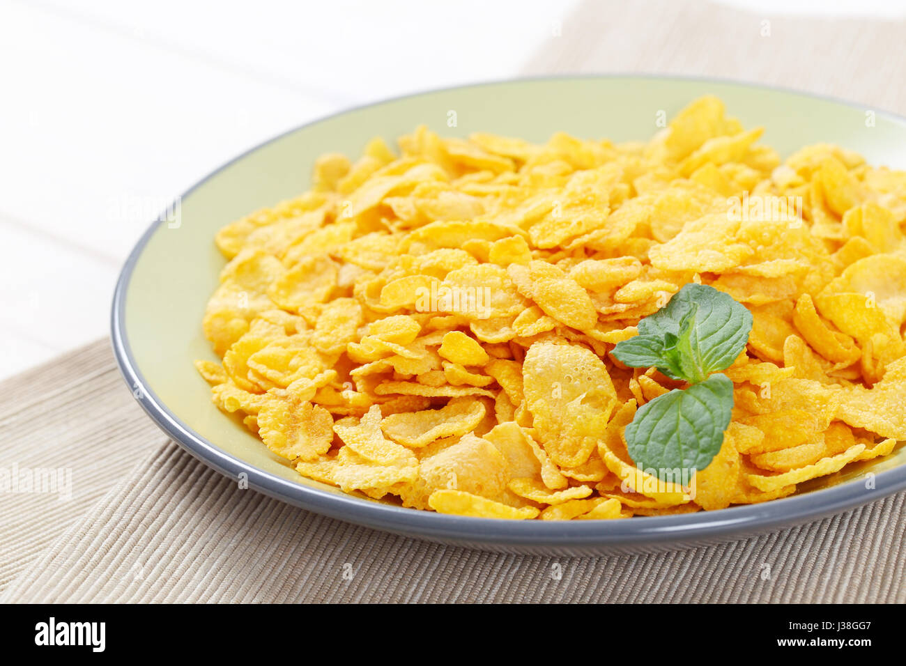 plate of corn flakes on beige place mat Stock Photo