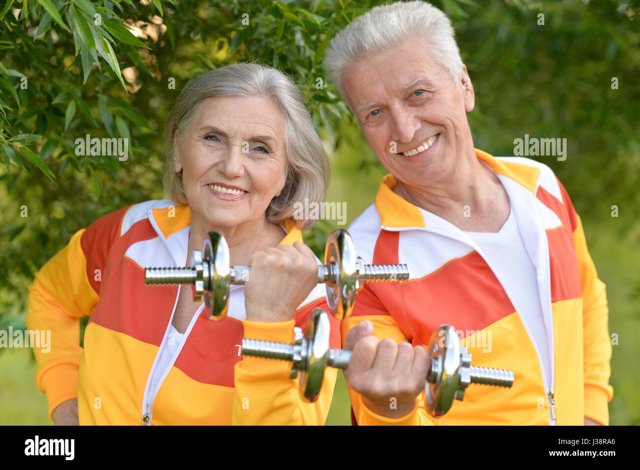 Beautiful elderly couple with dumbbells Stock Photo