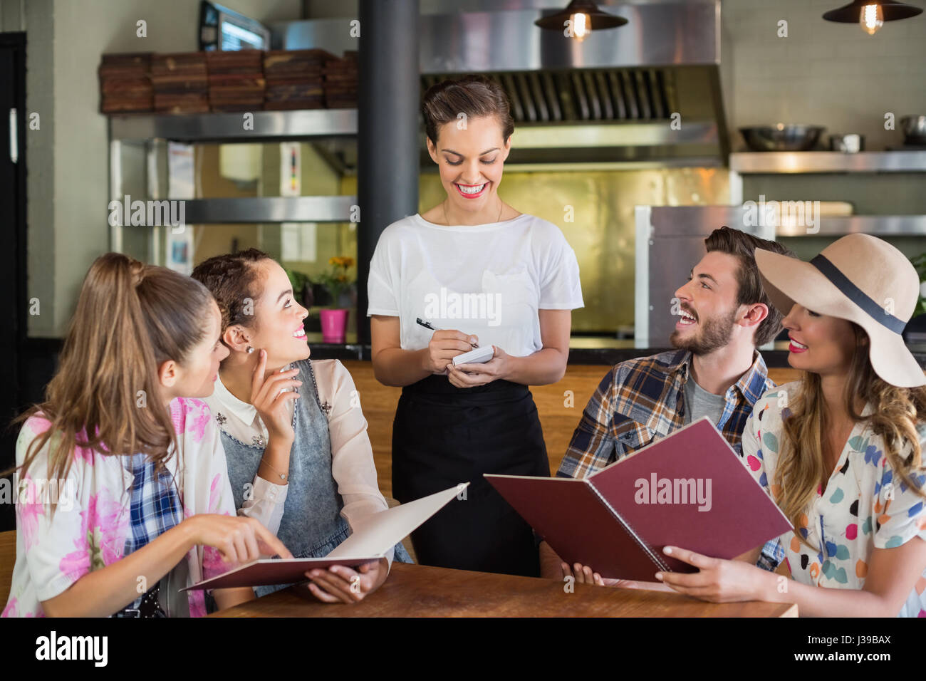 Script Being Waitress Smiling waitress writing orders of customers in restaurant Stock Photo ...
