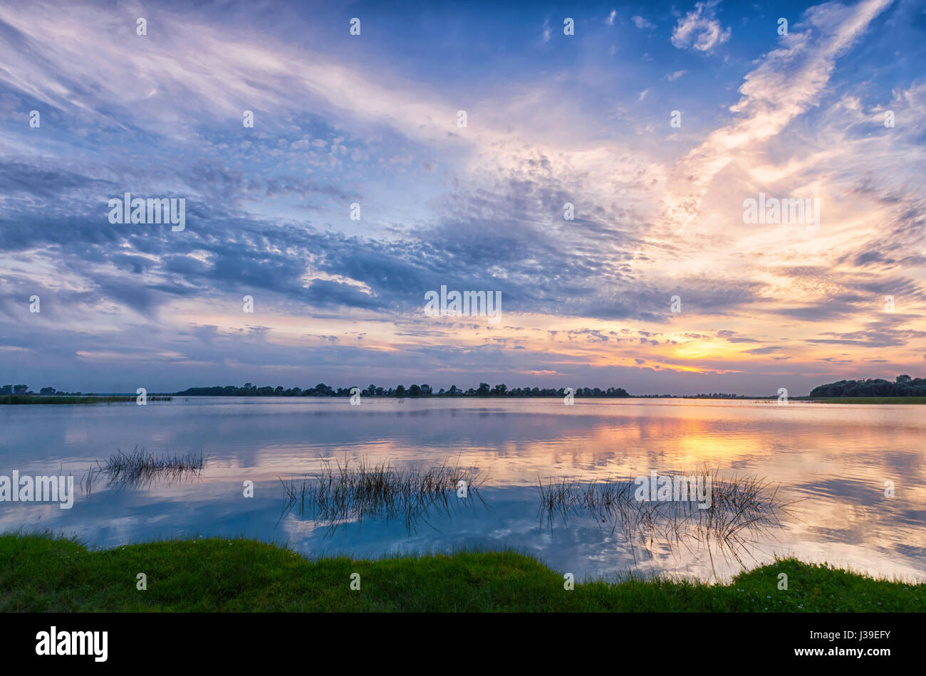 Sunset over the River, beautiful sky and reflection Stock Photo