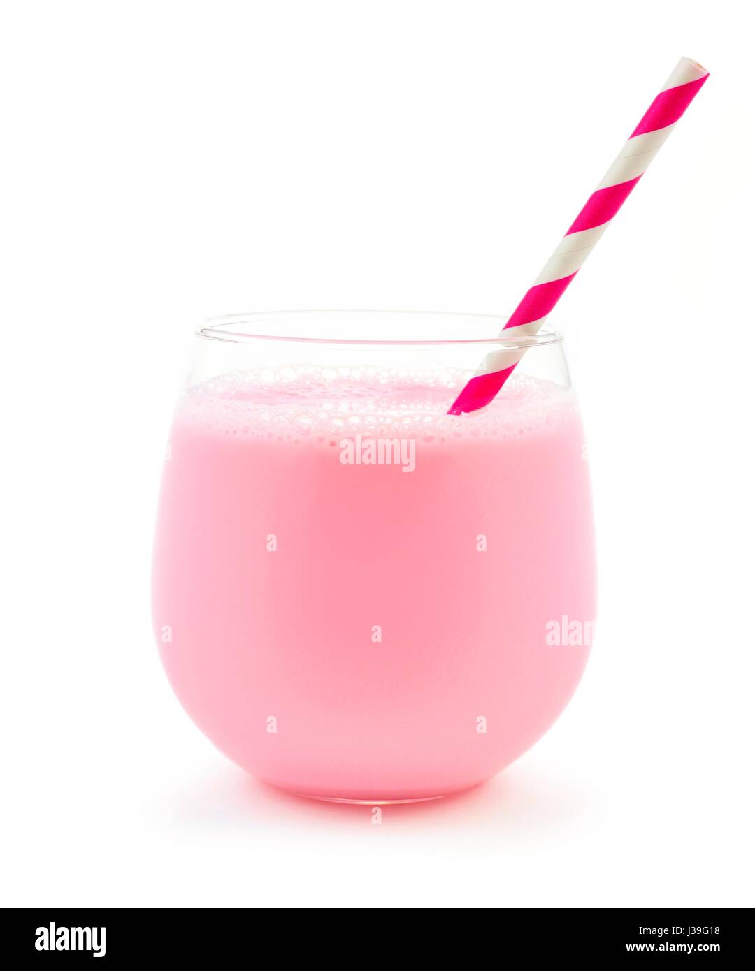 Strawberry milk in a glass tumbler with striped paper straw isolated on a white background Stock Photo
