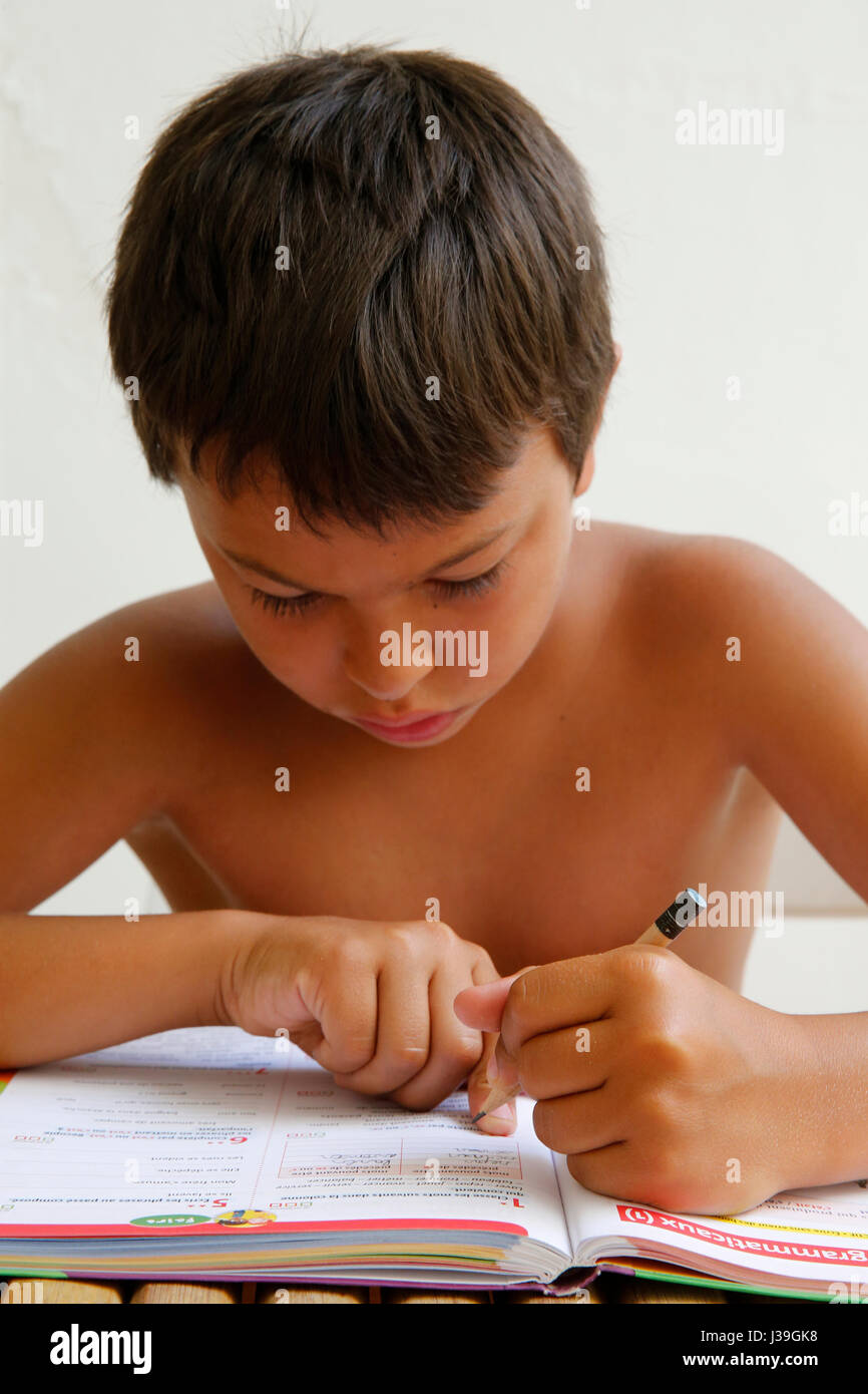 Boy doing schoolwork on vacation. Stock Photo