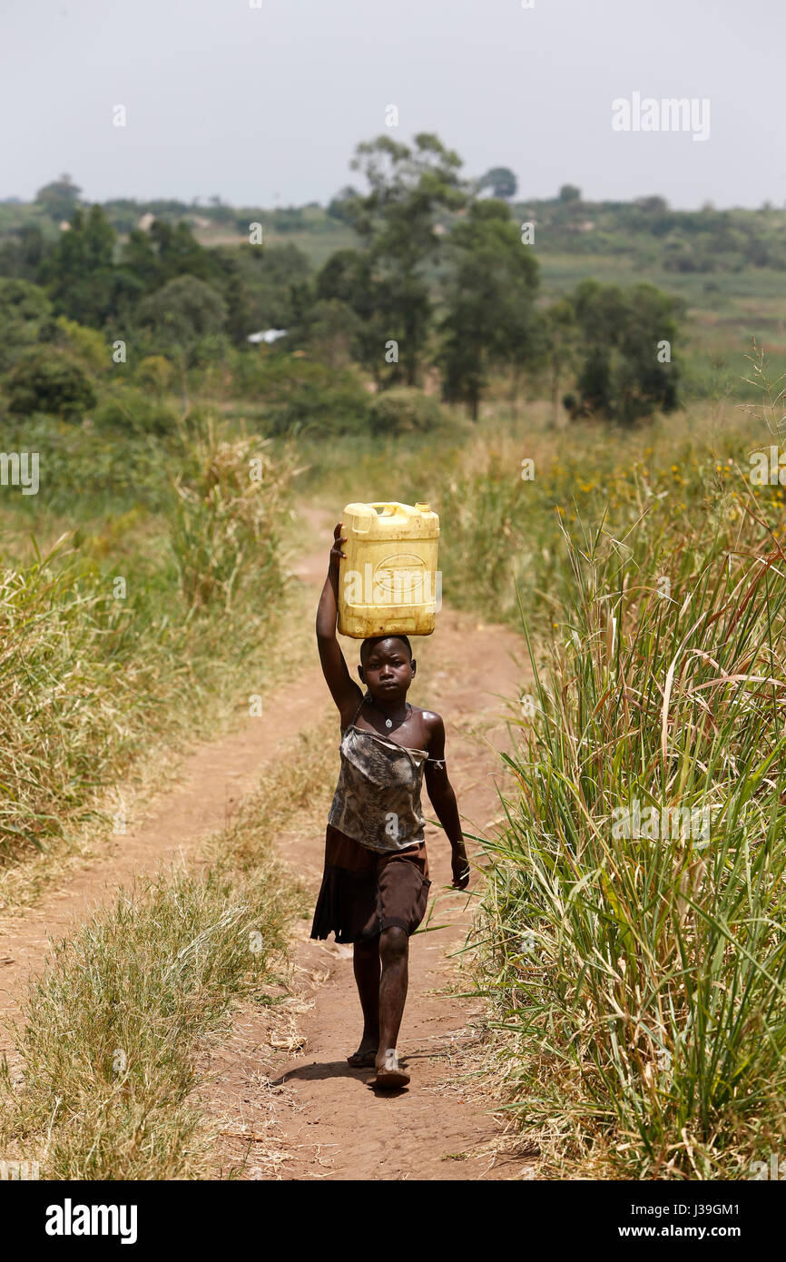 Ugandan child fetching water. Stock Photo