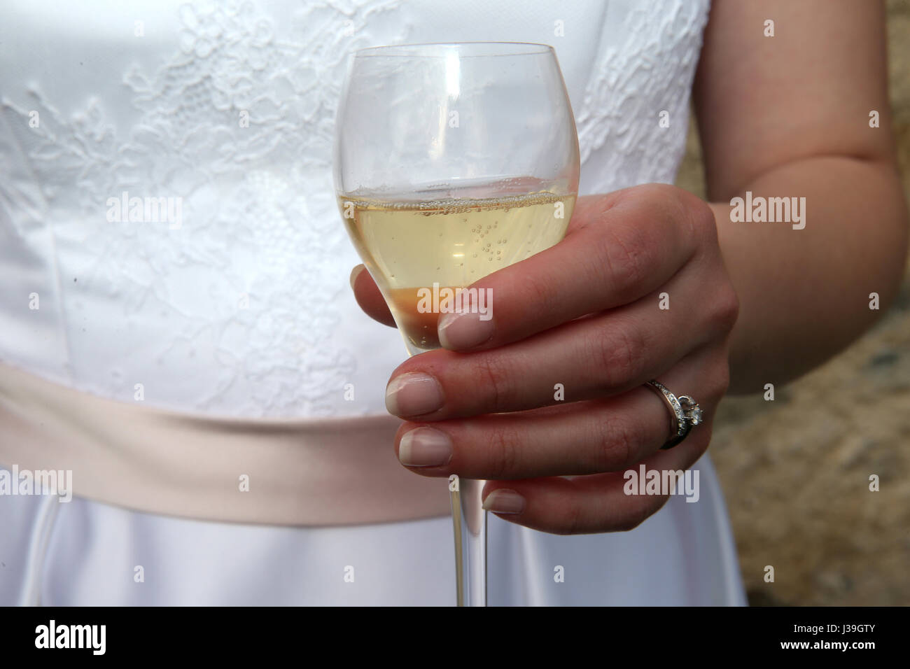 Bride holding a glass of champagne. Stock Photo