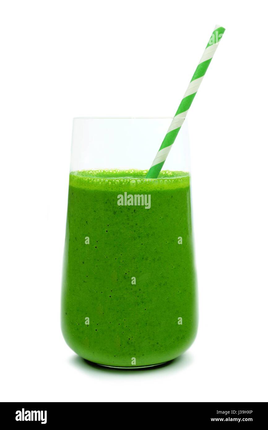 Green smoothie in a glass with striped paper straw isolated on a white background Stock Photo