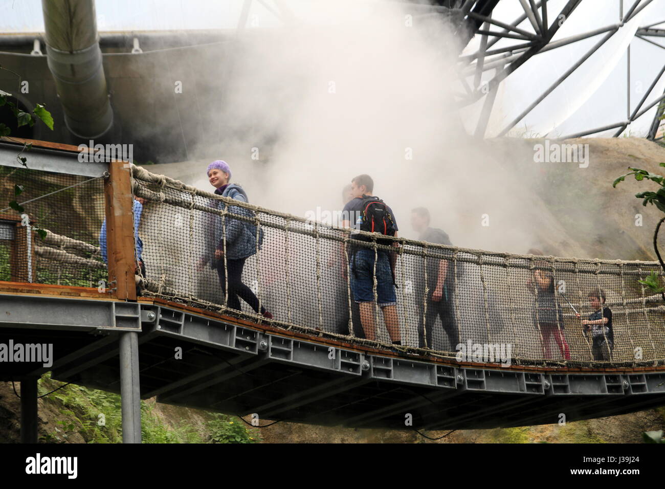 Bodelva, Cornwall, UK - April 4 2017: Unidentified guests in a cloud of steam in the Tropical biome at the Eden Project in Cornwall, England Stock Photo