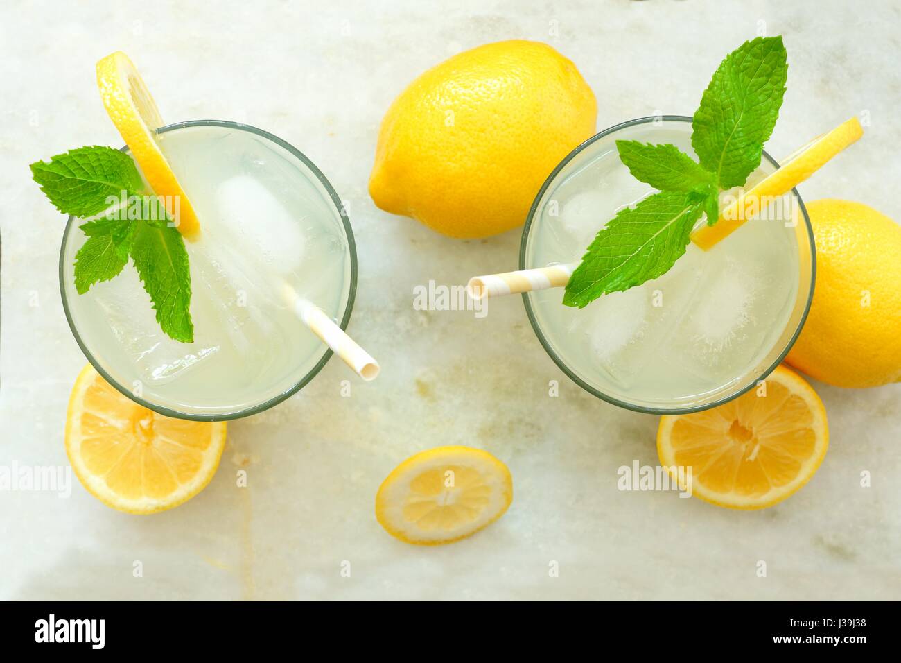 Two glasses of lemonade with mint, overhead view on a white marble background Stock Photo