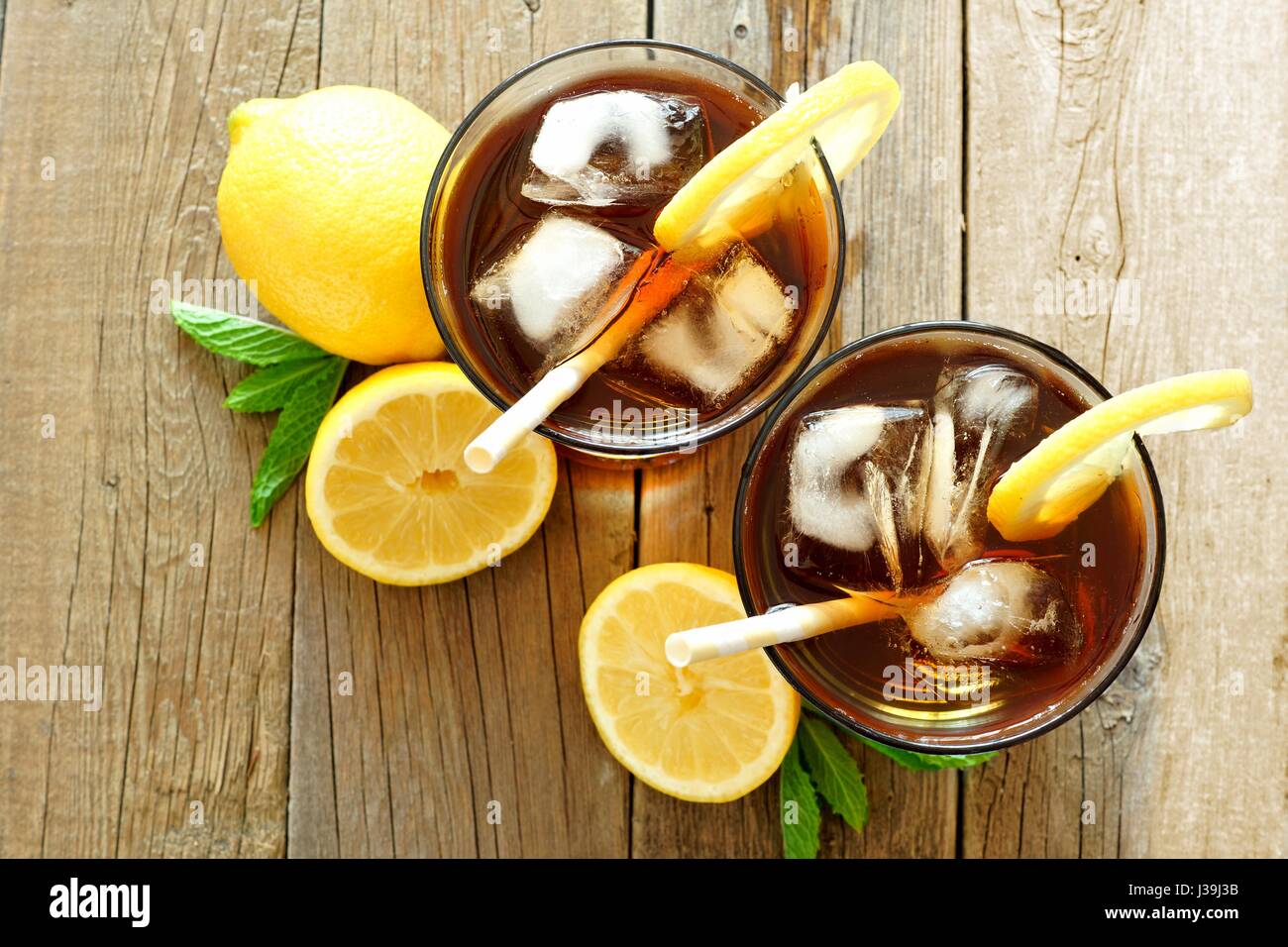Two glasses of iced tea with lemon, overhead view on a rustic wooden background Stock Photo