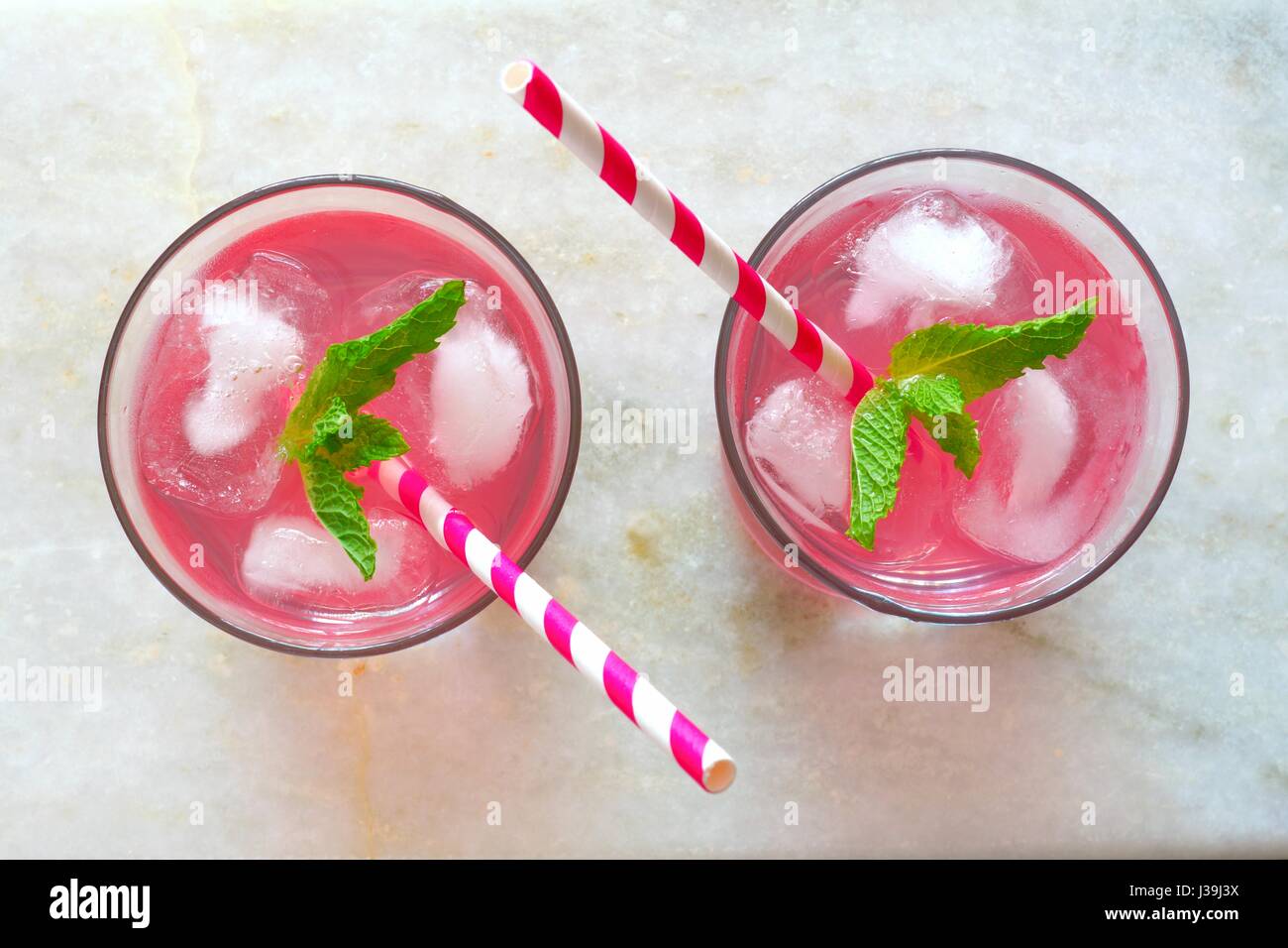Two glasses of pink lemonade with mint, overhead view on a white marble background Stock Photo
