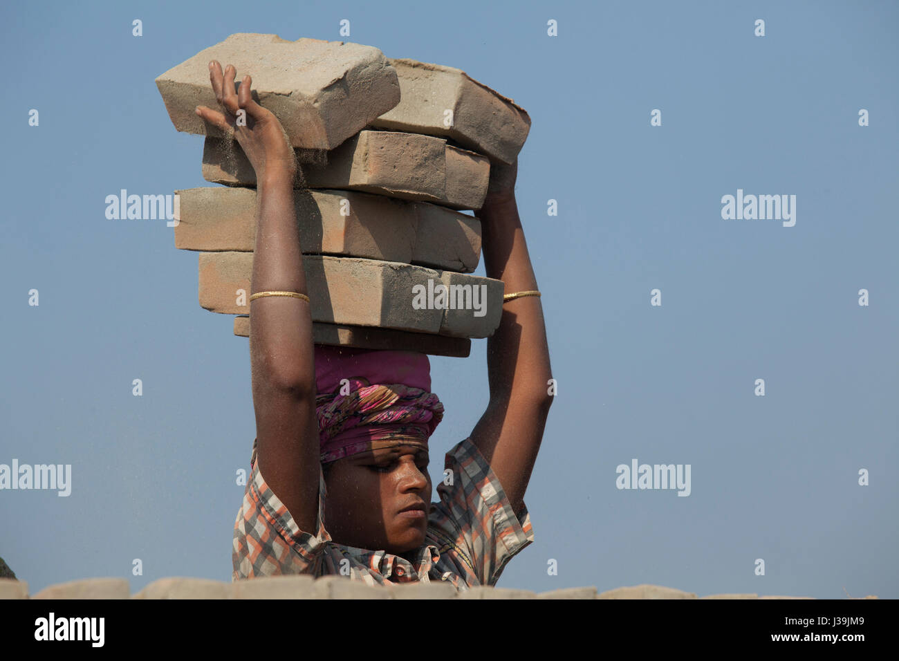Female labourer works at brickfield at Amin Bazar. Dhaka, Bangladesh. Stock Photo