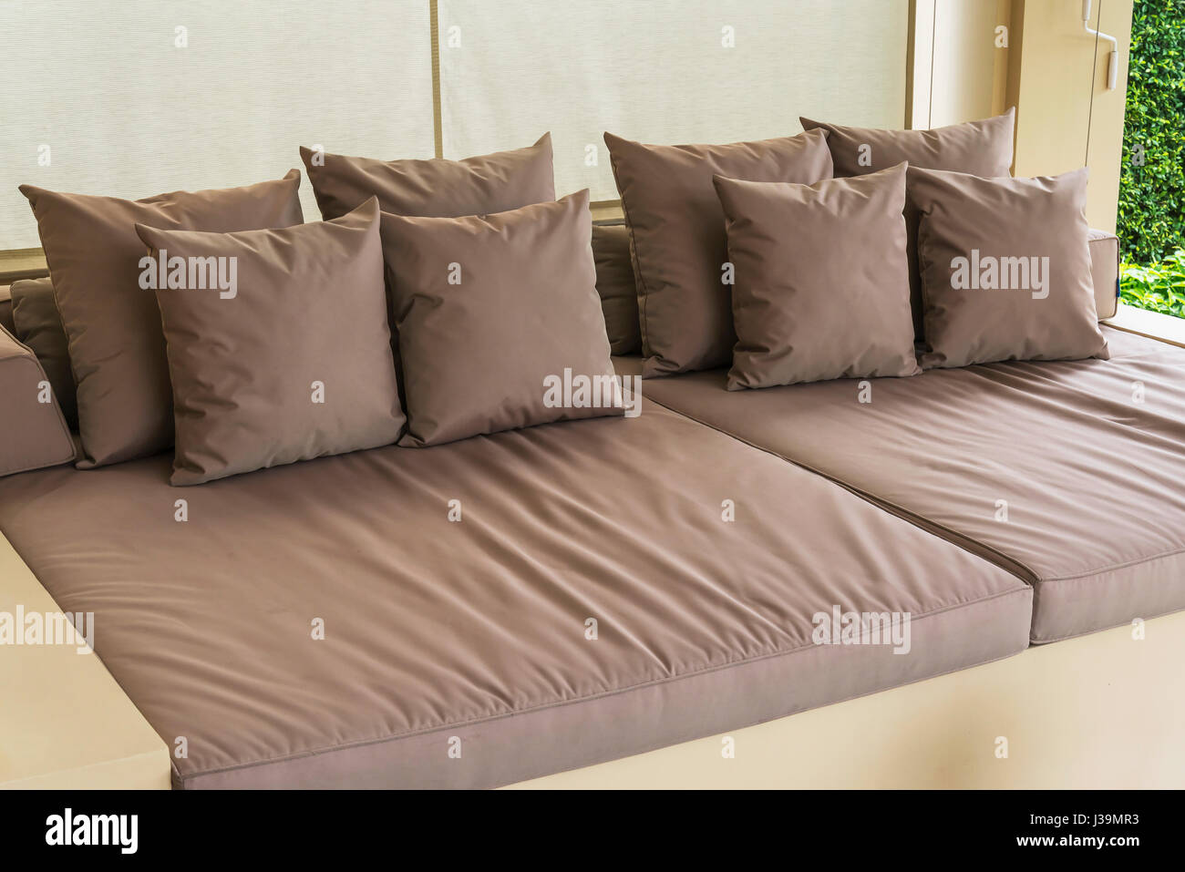 Outdoor Patio Seating Area With Big Brown Sofa And Pillows Stock