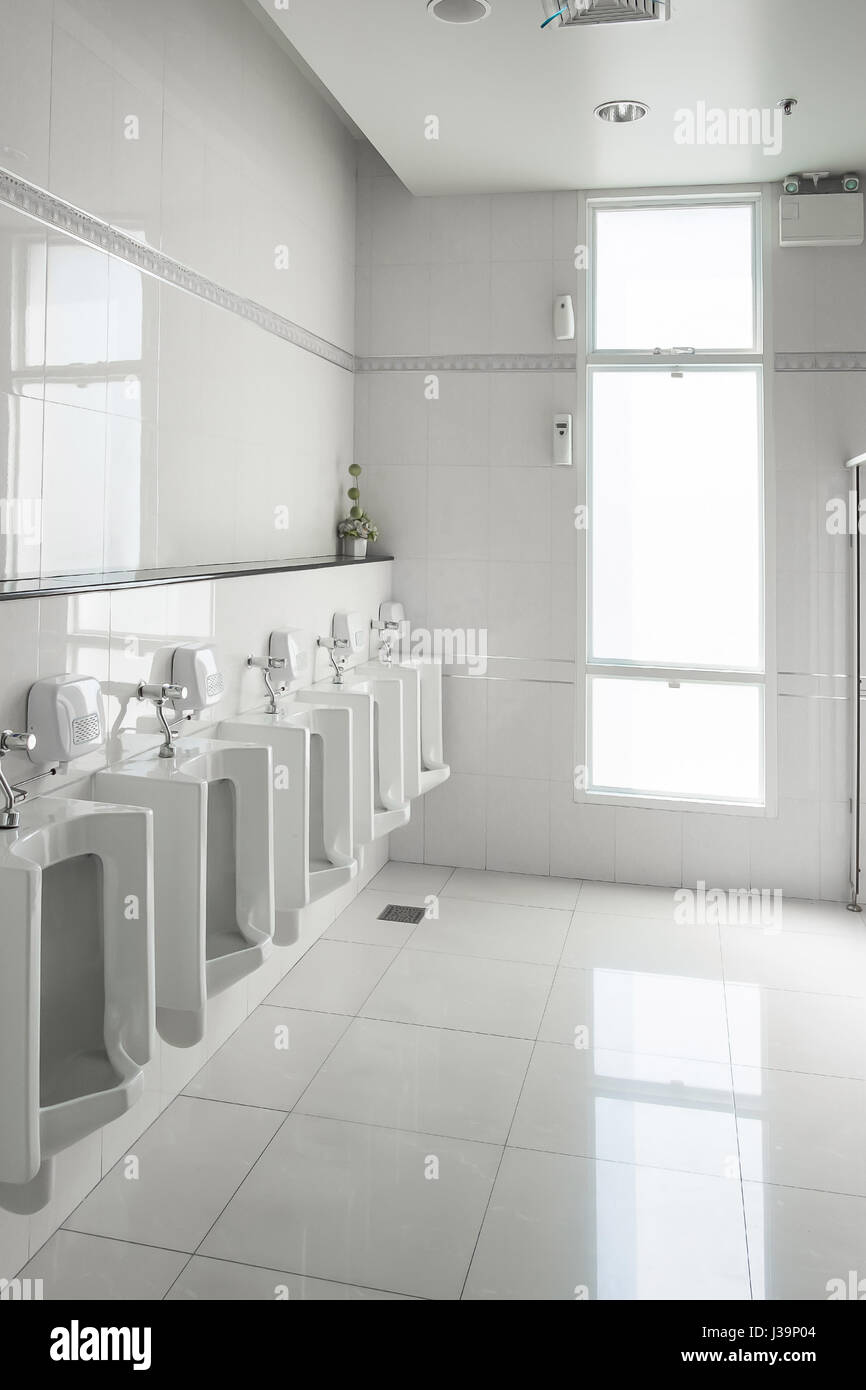 Window Urinal White urinals in clean men public toilet room empty with big window and ...