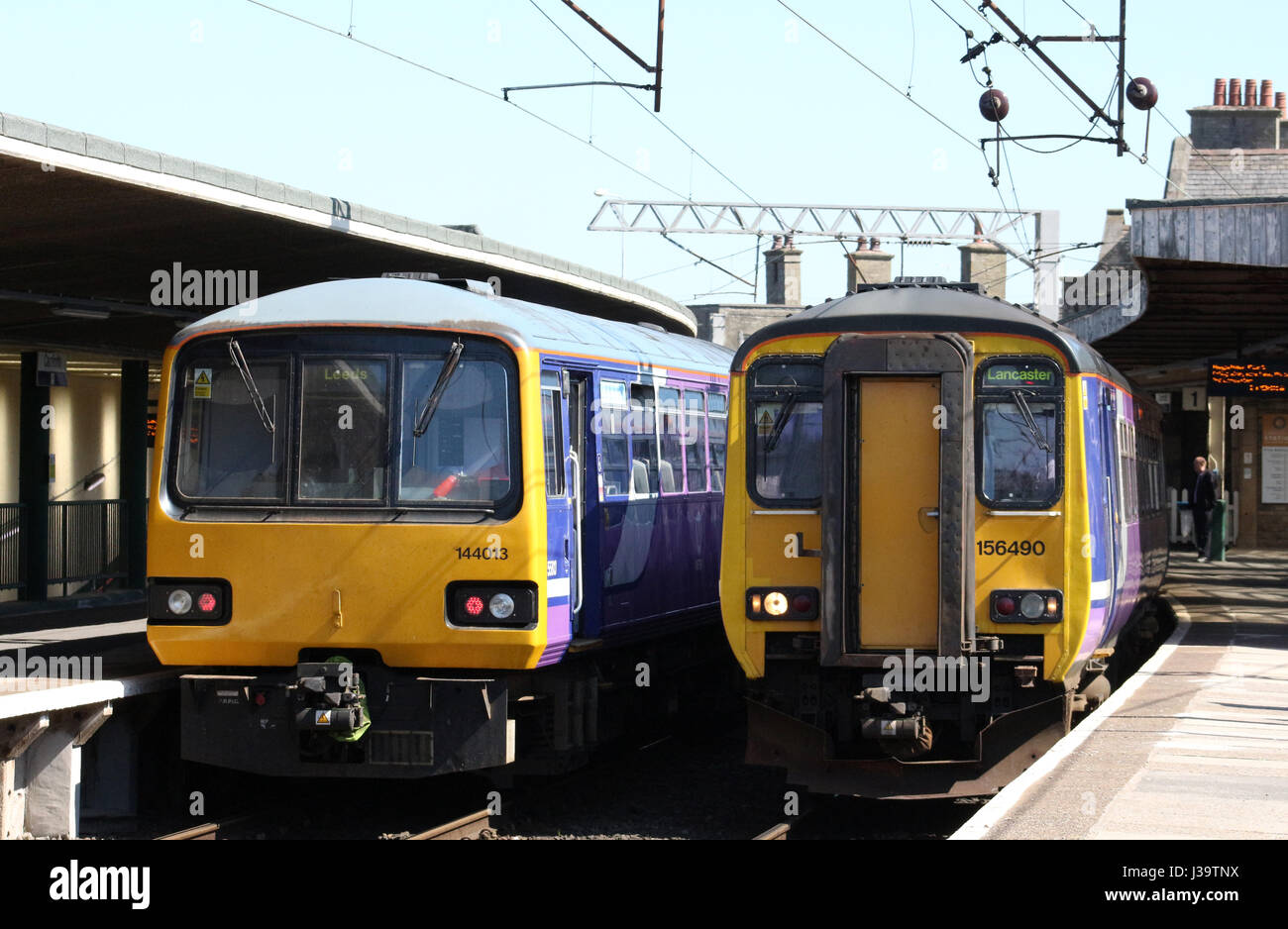 Two diesel multiple unit trains operated by Arrive Trains North in platforms 1 and 2 at Carnforth. Class 144 Pacer and class 156 Super Sprinter. Stock Photo