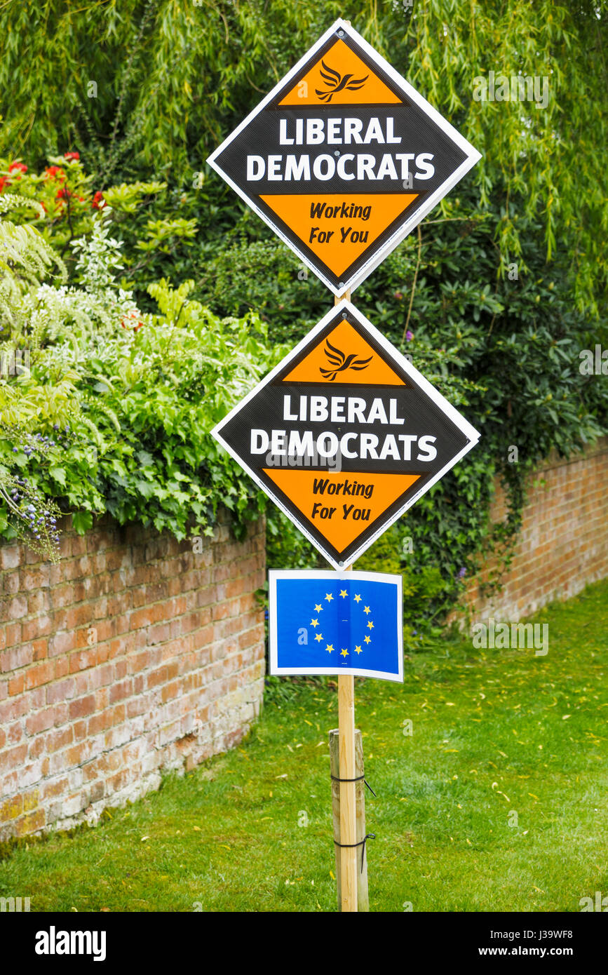 Roadside orange diamond-shaped boards, placards or signs on grass verge supporting and electioneering for the Liberal Democrat political party Stock Photo