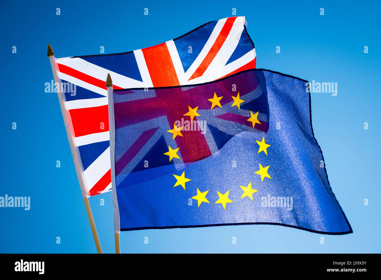 EU European Union and Scottish flags flying together in Brexit solidarity in bright blue sky Stock Photo