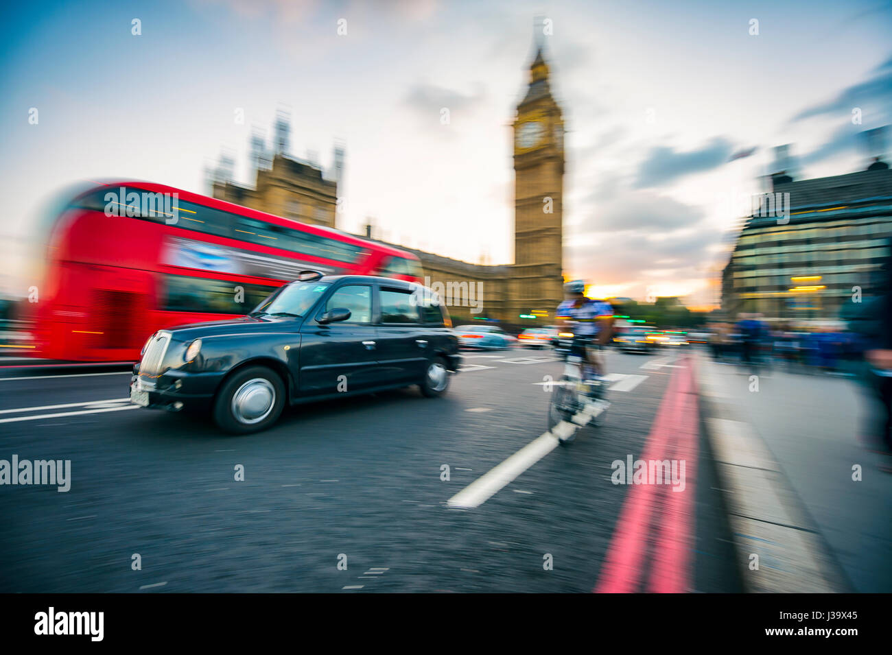 LONDON - OCTOBER 4, 2016: Traffic passes in motion blur on Westminster Bridge, a busy crossing that passes next to Houses of Parliament and Big Ben. Stock Photo