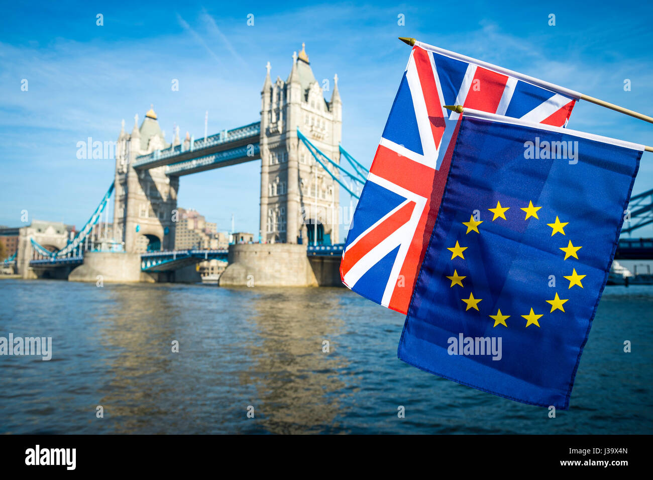 EU European Union and UK United Kingdom flags flying together in Brexit solidarity in front of the London, England skyline at Tower Bridge Stock Photo