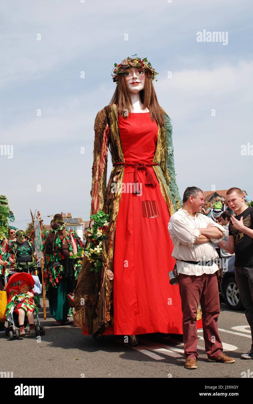 Flora, the Singleton Giant, is paraded on the West Hill, during the annual Jack In The Green festival at Hastings, England on May 5, 2014. Stock Photo