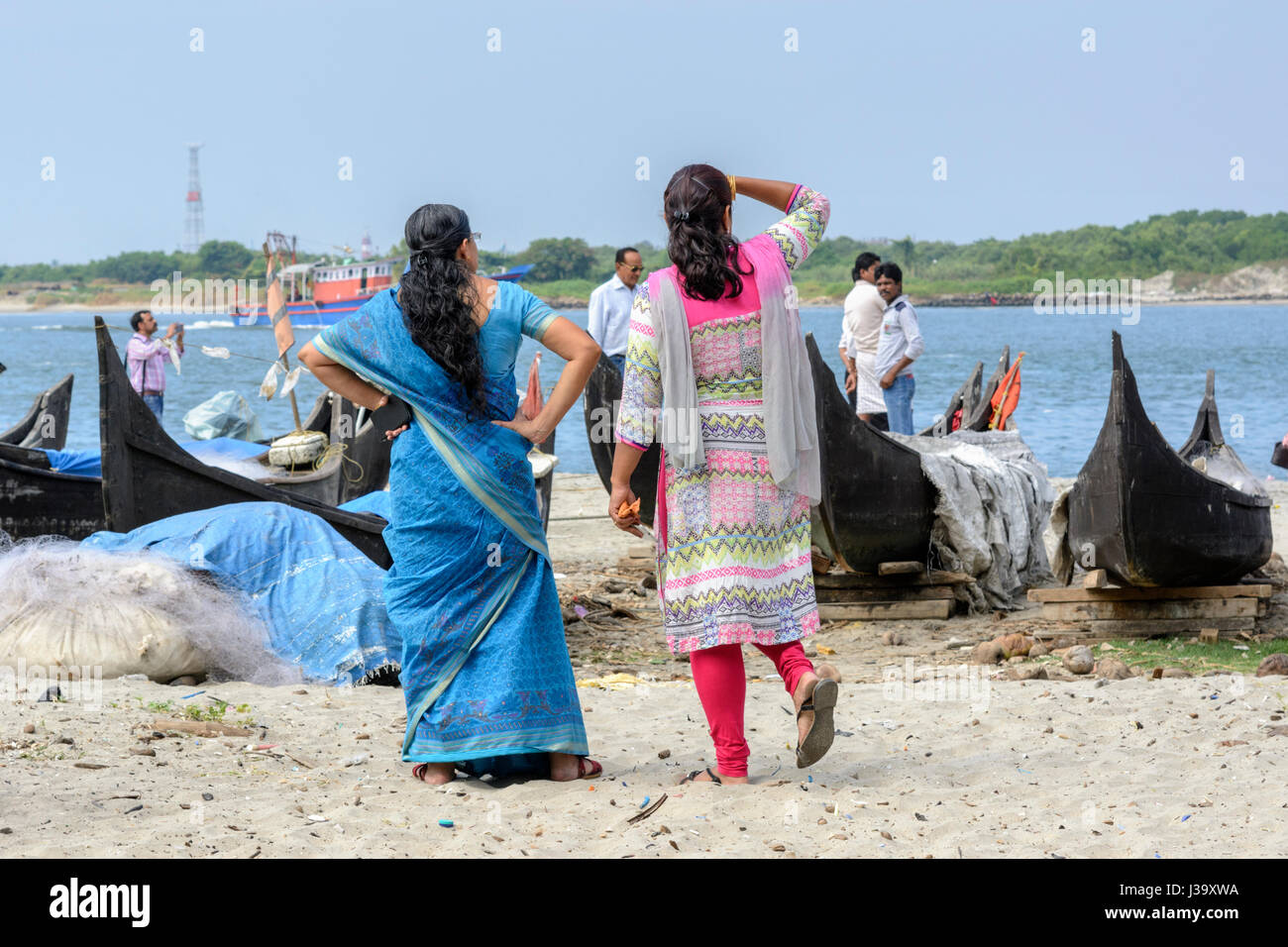 Two local women wearing traditional clothes walk along the beach to see the  fishing boats in Fort Kochi (Cochin), Kerala, South India, South Asia Stock  Photo - Alamy