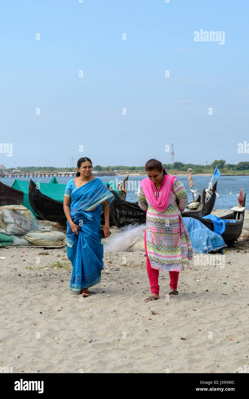 https://c8.alamy.com/comp/J39XWC/two-local-women-wearing-traditional-clothes-walk-along-the-beach-to-J39XWC.jpg