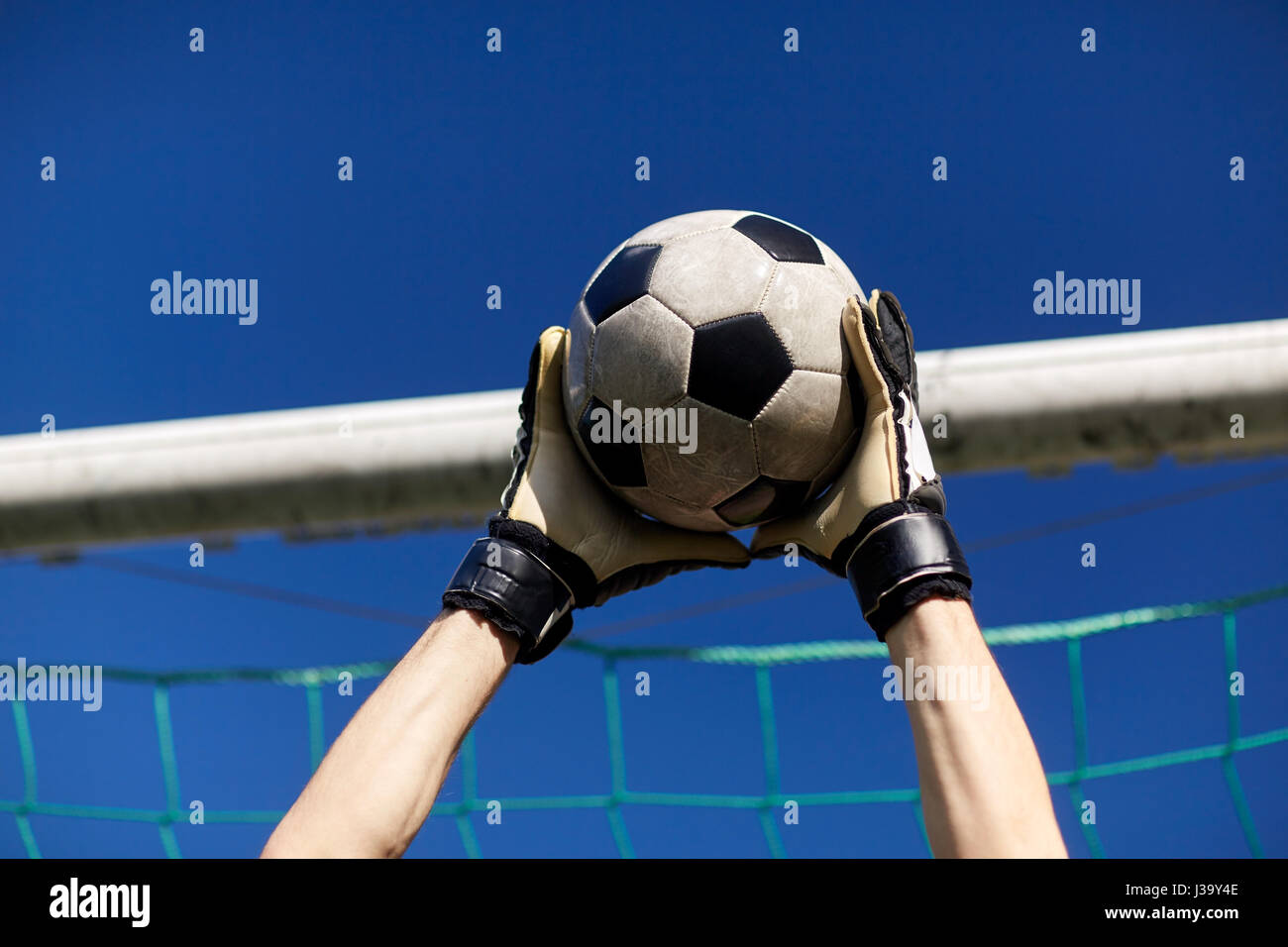 goalkeeper with ball at football goal over sky Stock Photo Alamy