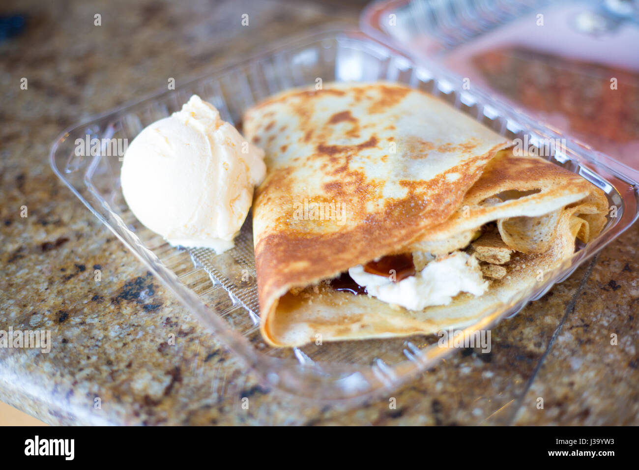 Closeup shot of s'mores crepe with vanilla bean ice cream, isolated marble table background Stock Photo
