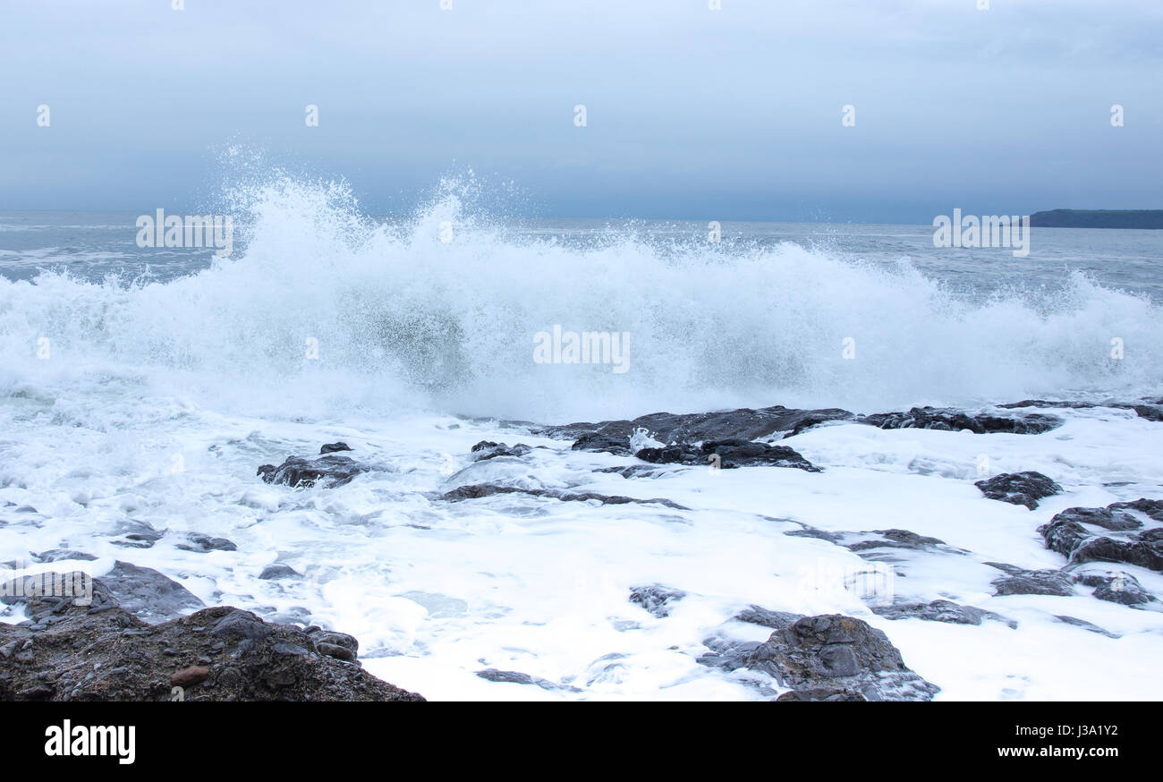 Waves breaking on rocks at high tide Stock Photo