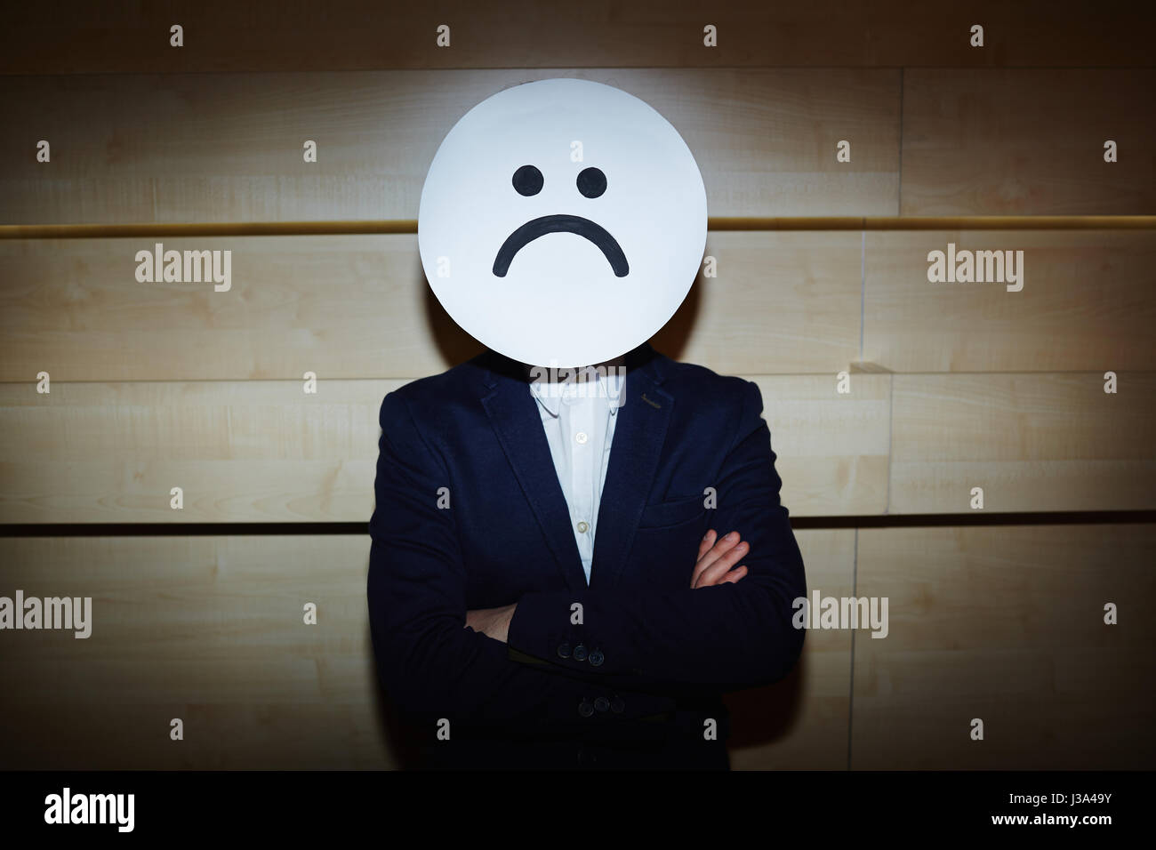 Businessman in Sad Mask Stock Photo