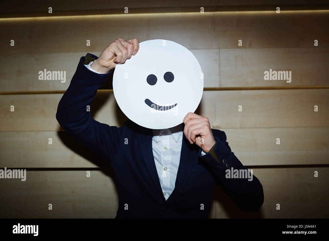 Successful Entrepreneur in Smiling Mask Stock Photo