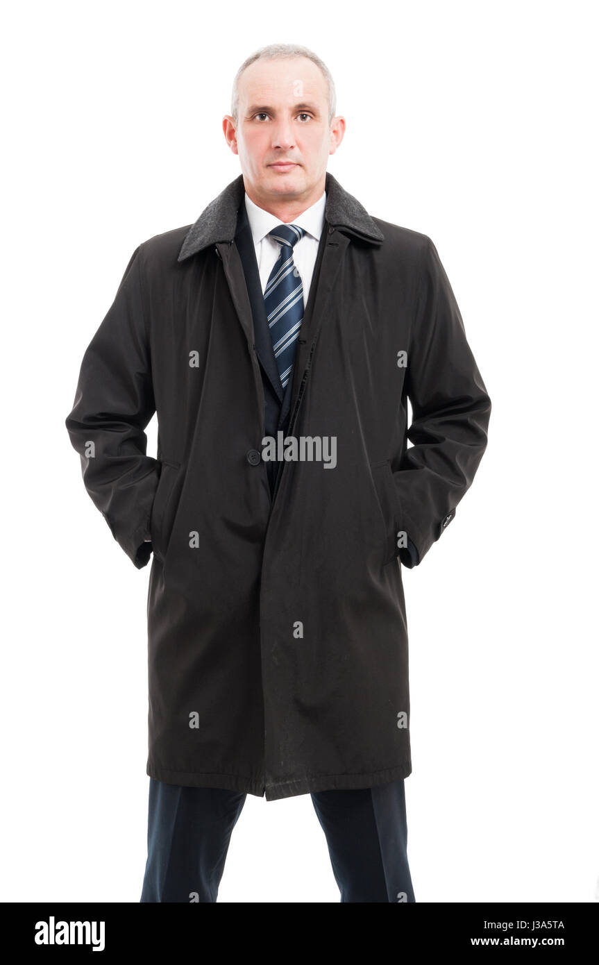 Portrait of middle age business man posing in raincoat looking serious isolated on white background Stock Photo