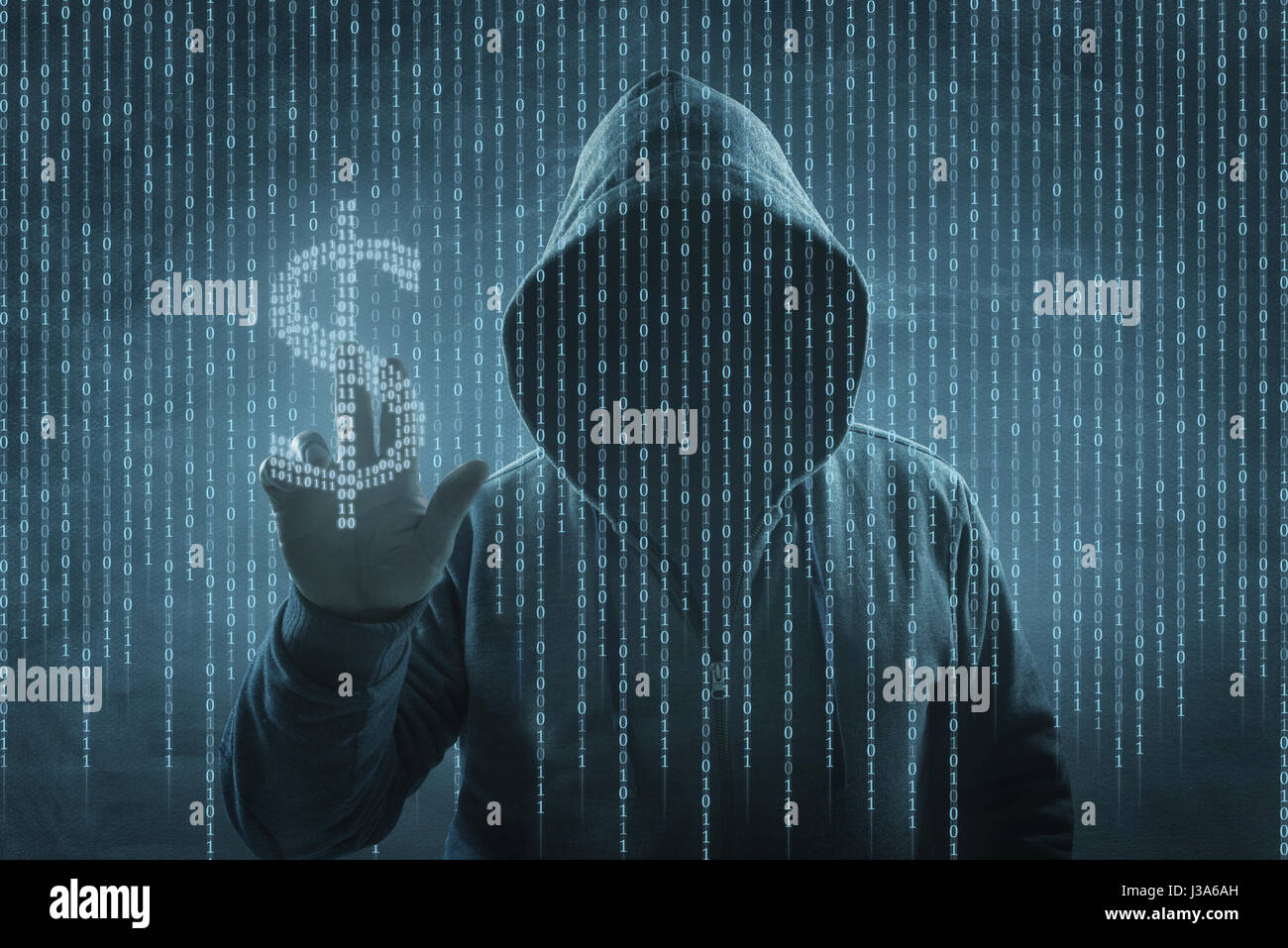 hacker over a screen with binary code Stock Photo