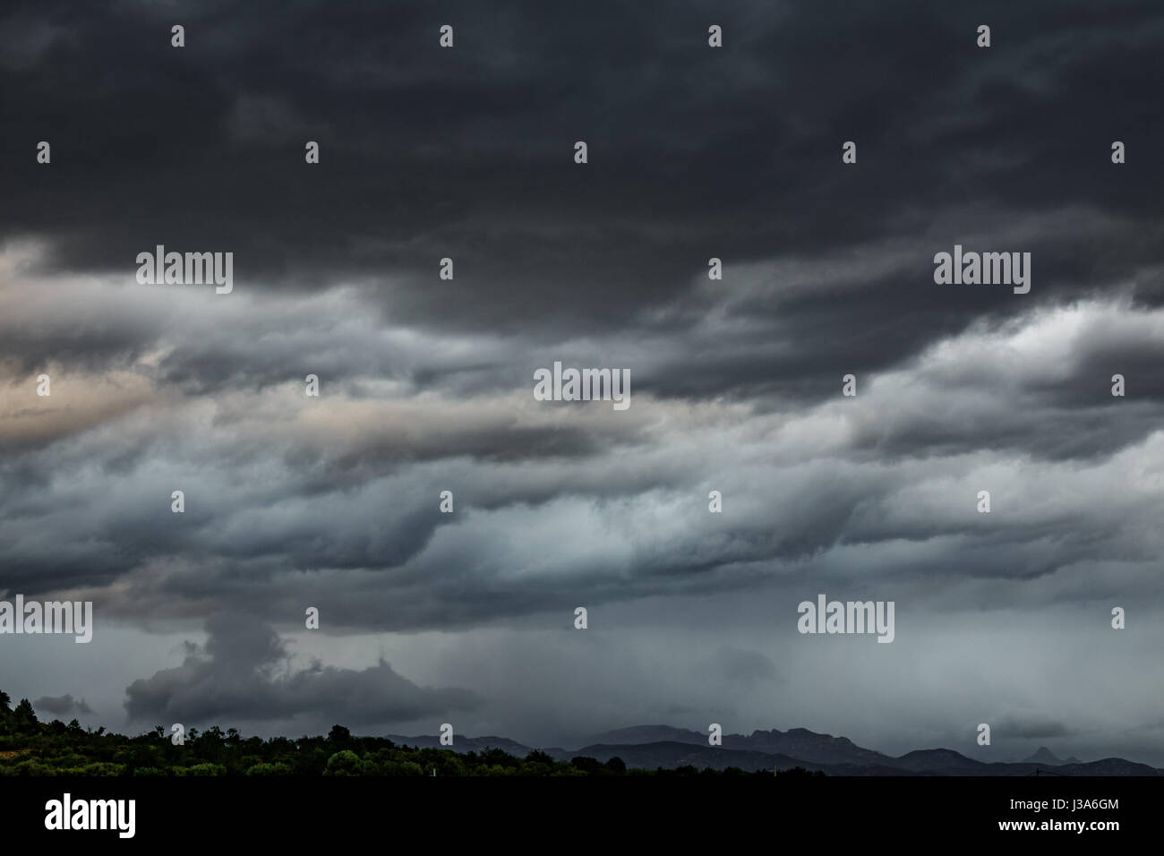 Cloudy sky, dark clouds, close storm over mountain range Stock Photo ...