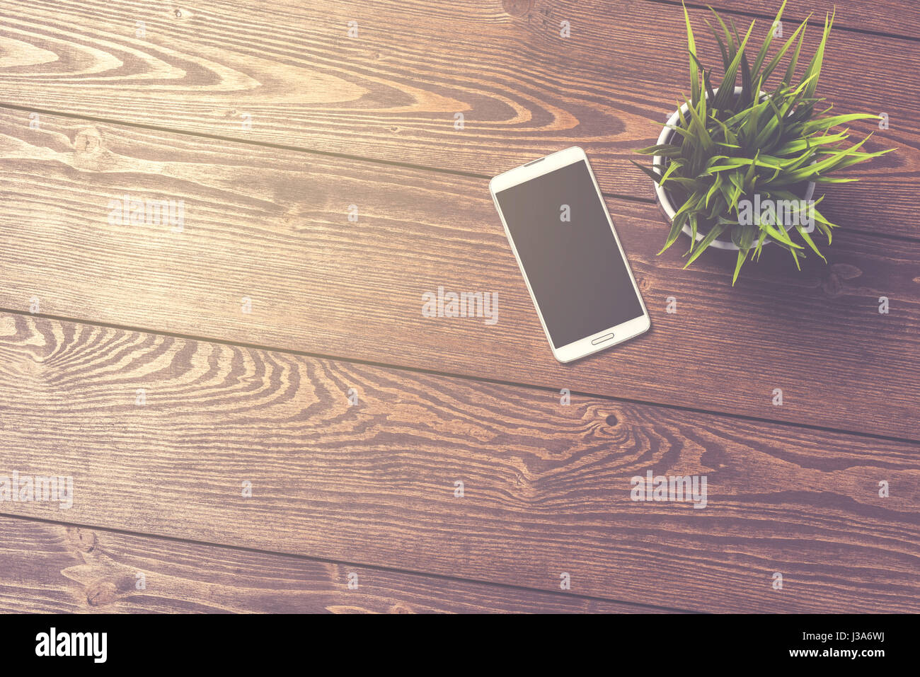 White smart phone on wooden table Stock Photo Alamy